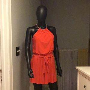 Orange romper with gold chain type closure size small